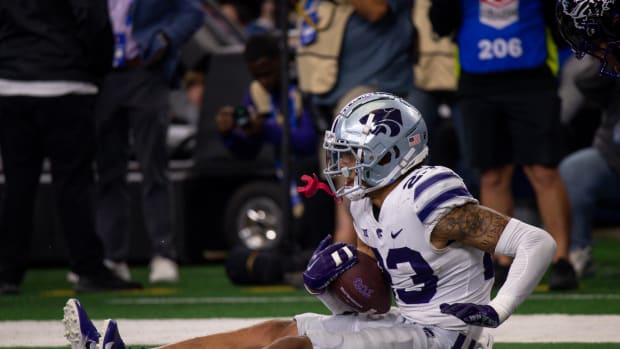 Dec 3, 2022; Arlington, TX, USA; Kansas State Wildcats cornerback Julius Brents (23) falls back into the end zone after incepting a pass thrown by TCU Horned Frogs quarterback Max Duggan (15) during the second half at AT&T Stadium.
